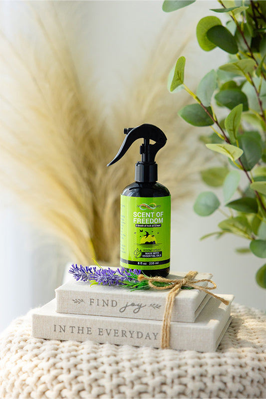 Scent of Freedom plant-based room spray by Aroma Sanctuary, styled with lavender and placed on a neutral textured surface